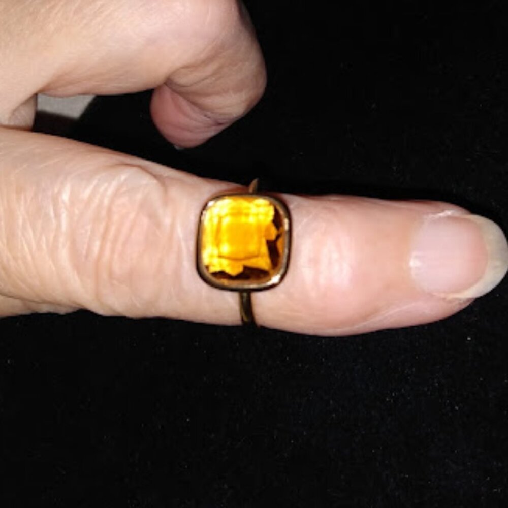 Michael Kors: Gold tone ring with yellow stone. Size 6.